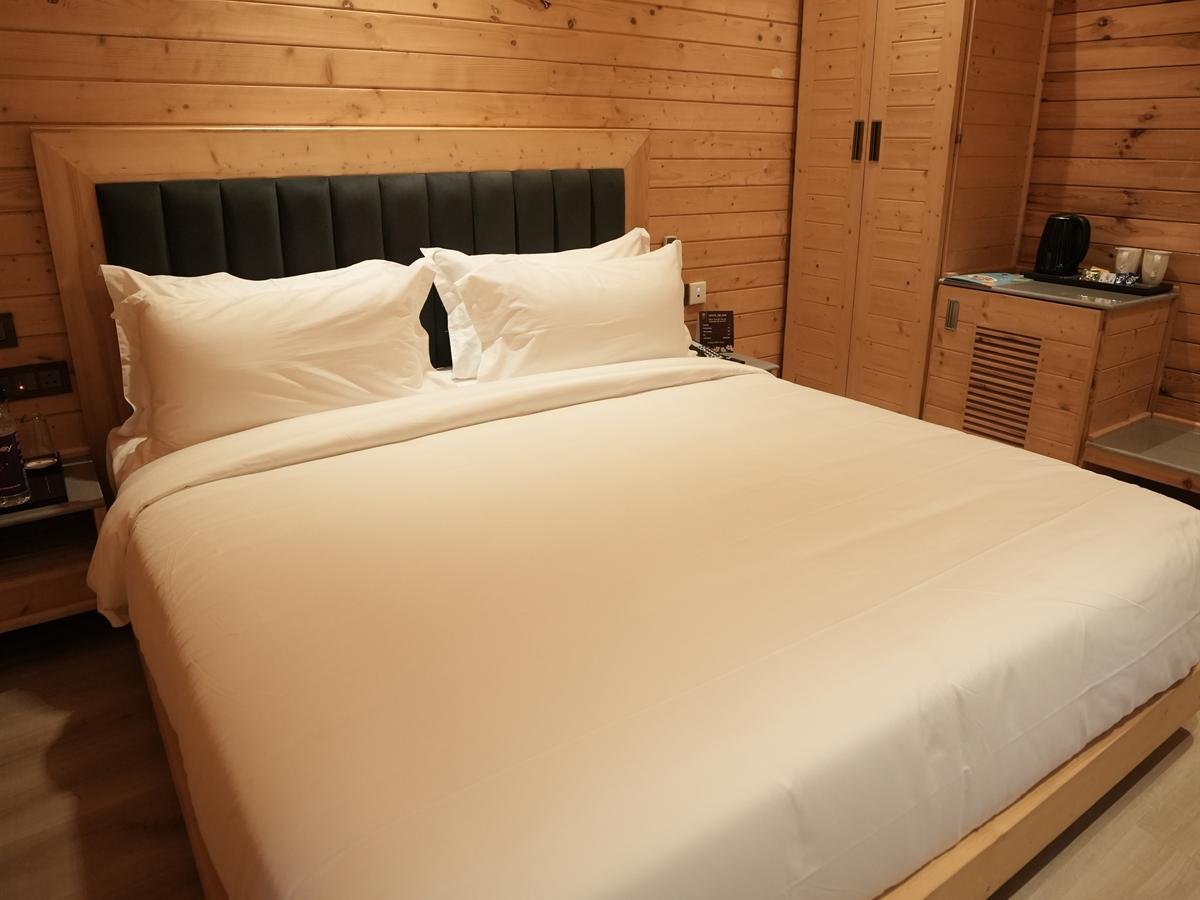 Standard Cottage bedroom with king-size bed and pine-clad walls