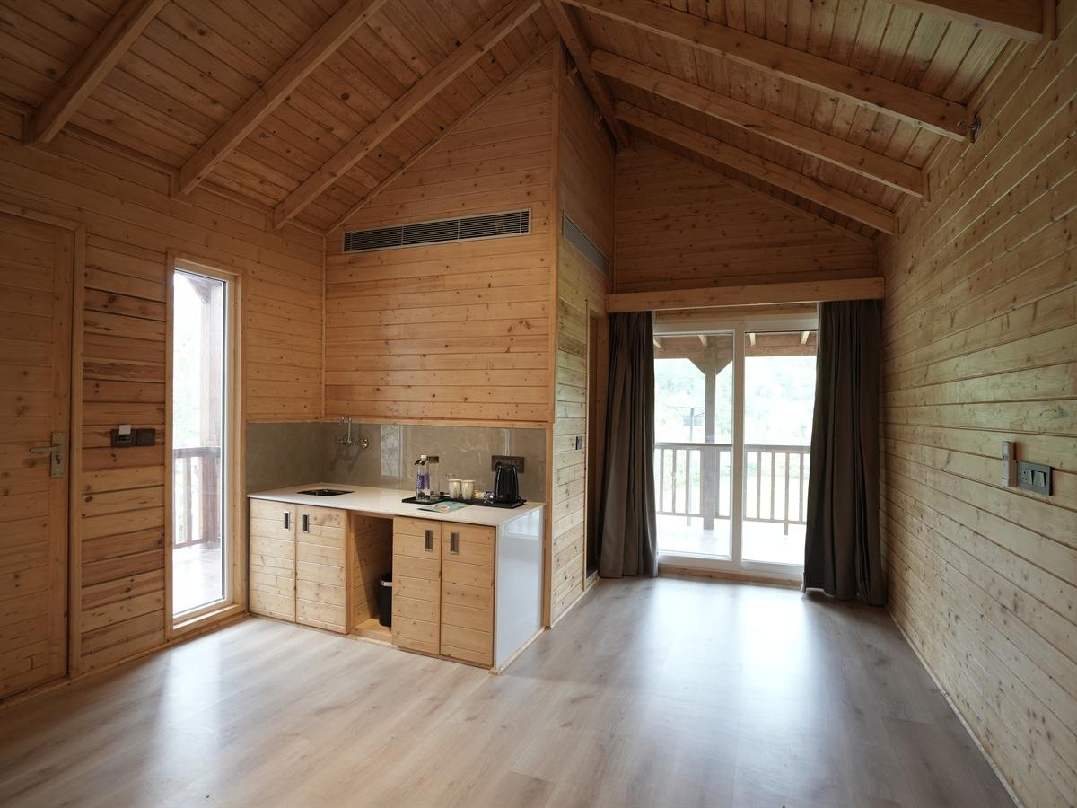 Suite Cottage living area and kitchenette opening onto the balcony