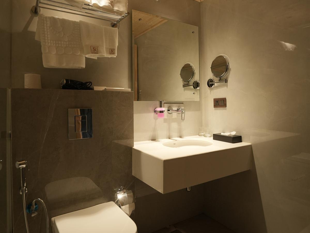 Suite Cottage bathroom vanity beneath a timber ceiling